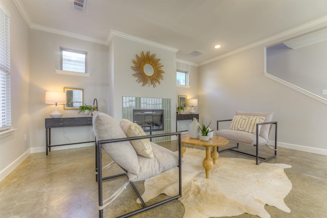 sitting room featuring finished concrete flooring, baseboards, and visible vents