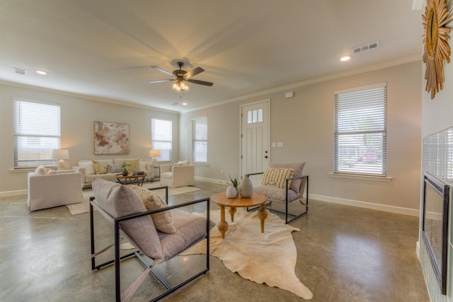 living area featuring baseboards, concrete floors, visible vents, and a wealth of natural light