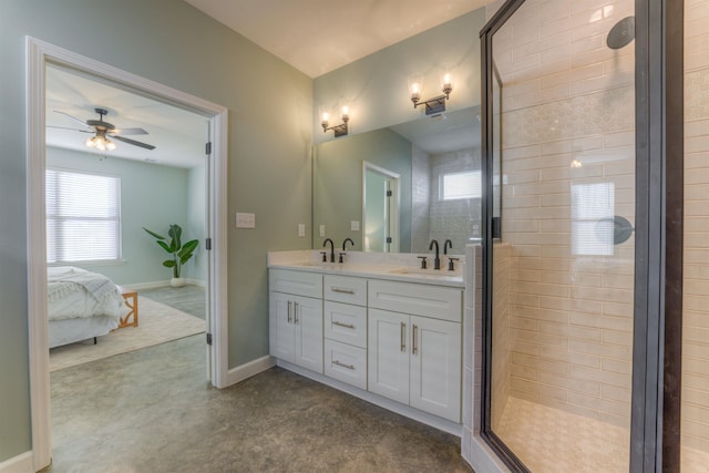 bathroom with double vanity, a stall shower, baseboards, and a sink