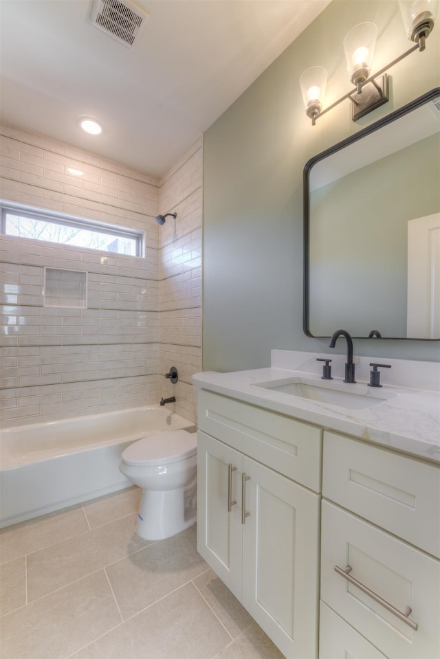 bathroom with visible vents, toilet, tile patterned floors, vanity, and shower / washtub combination