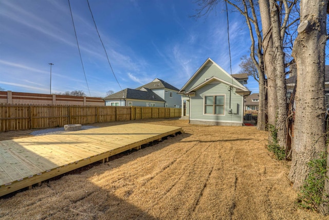 view of yard featuring a deck and a fenced backyard