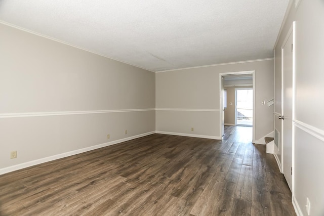 unfurnished room featuring crown molding, dark wood finished floors, a textured ceiling, and baseboards