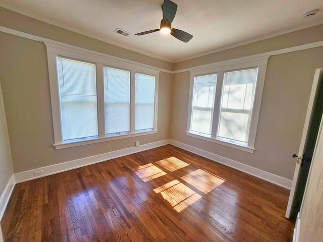 unfurnished room featuring visible vents, ceiling fan, baseboards, and wood finished floors