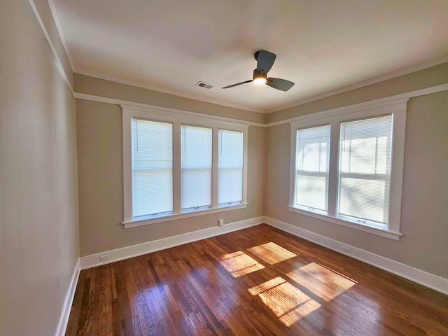 spare room featuring a ceiling fan, dark wood-style flooring, visible vents, and baseboards