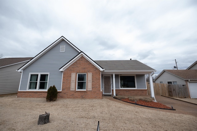 ranch-style home with brick siding and fence