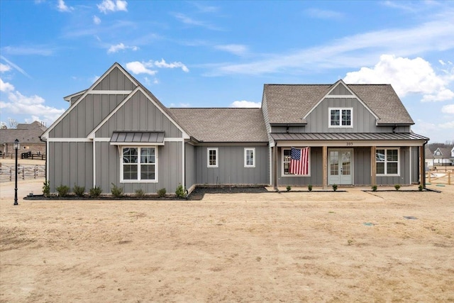 modern farmhouse with a standing seam roof and board and batten siding