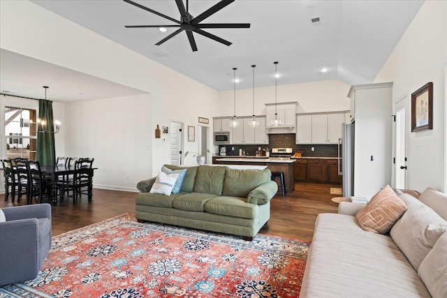 living room featuring recessed lighting, ceiling fan with notable chandelier, visible vents, baseboards, and dark wood-style floors