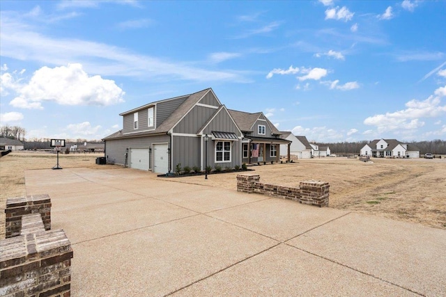 exterior space with concrete driveway, board and batten siding, and an attached garage