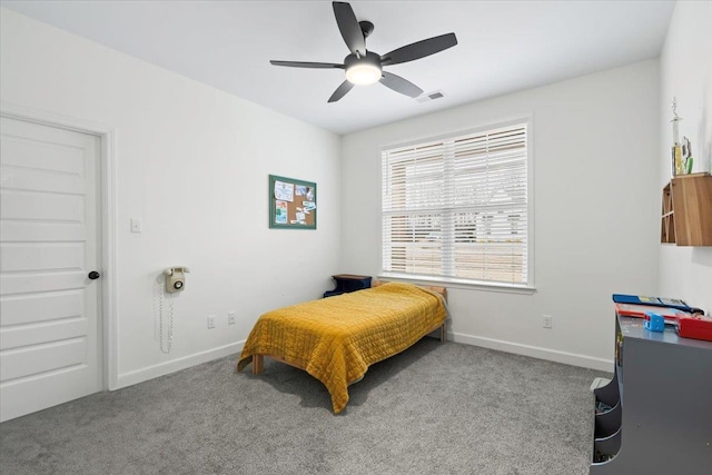 carpeted bedroom with baseboards, visible vents, and a ceiling fan