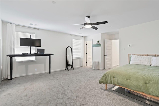 carpeted bedroom featuring ceiling fan, visible vents, and baseboards