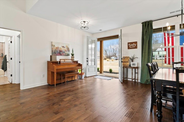 interior space with visible vents, wood finished floors, a wealth of natural light, and a notable chandelier