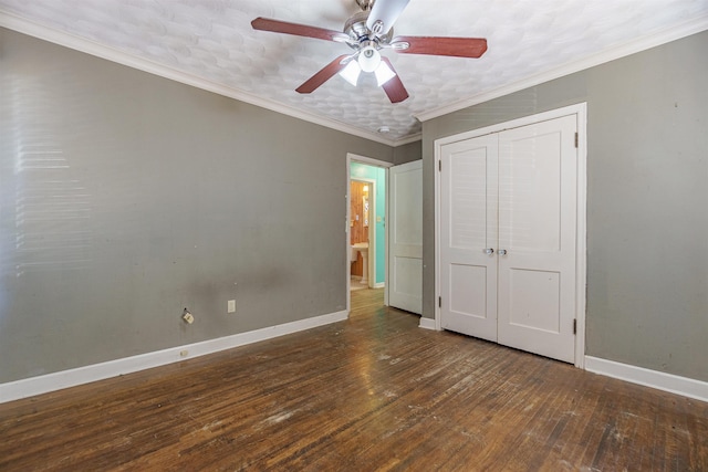 unfurnished bedroom with a closet, ornamental molding, a ceiling fan, baseboards, and hardwood / wood-style flooring