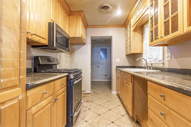 kitchen featuring visible vents, glass insert cabinets, ornamental molding, stainless steel appliances, and a sink