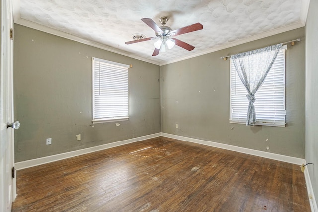 unfurnished room with ornamental molding, plenty of natural light, hardwood / wood-style floors, and baseboards