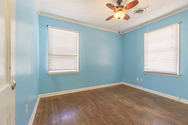 empty room with visible vents, baseboards, a ceiling fan, ornamental molding, and hardwood / wood-style floors