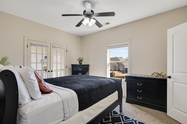 bedroom with light carpet, french doors, visible vents, and a ceiling fan