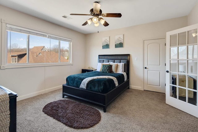 carpeted bedroom featuring ceiling fan, visible vents, and baseboards