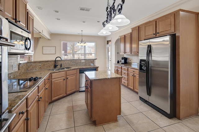 kitchen featuring visible vents, appliances with stainless steel finishes, ornamental molding, light tile patterned flooring, and a sink