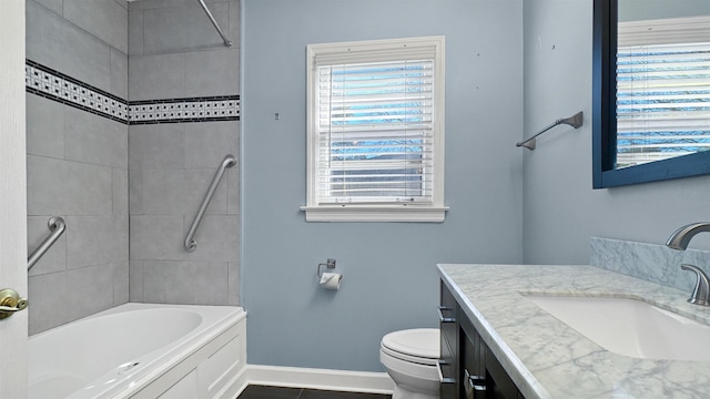 full bath featuring toilet, plenty of natural light, baseboards, and vanity