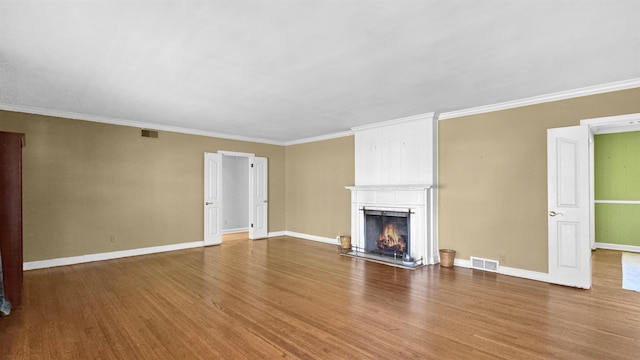 unfurnished living room featuring baseboards, a fireplace, visible vents, and wood finished floors