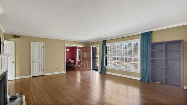 unfurnished living room with a fireplace, visible vents, ornamental molding, wood finished floors, and baseboards