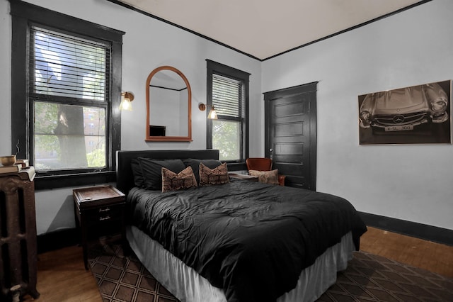 bedroom featuring baseboards and wood finished floors