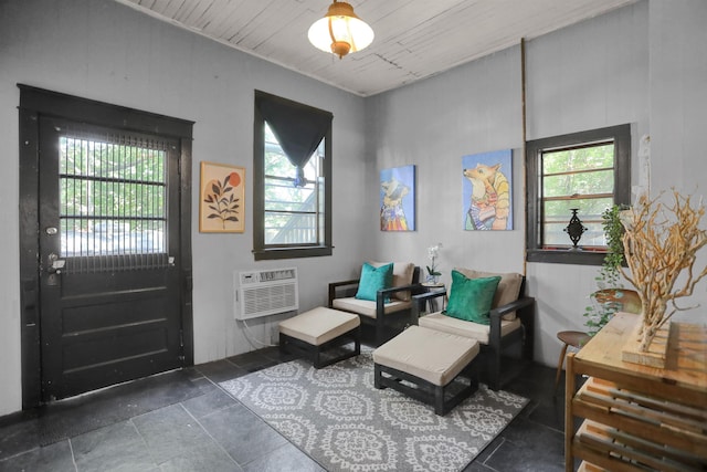 living area featuring a wall mounted AC and wood ceiling