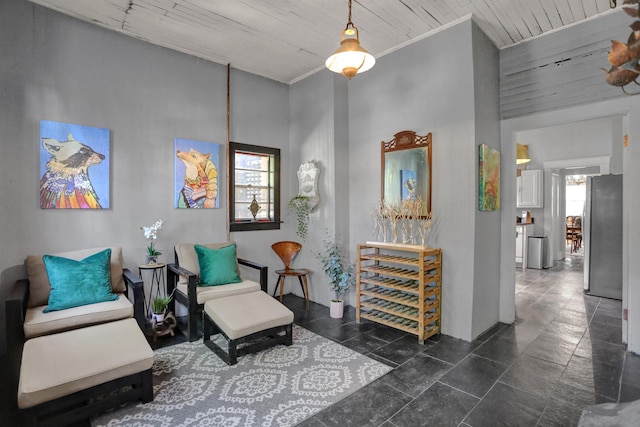 living area with wood ceiling and crown molding