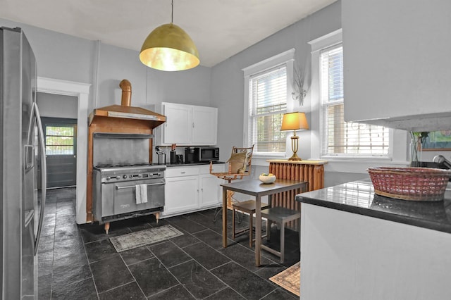 kitchen featuring appliances with stainless steel finishes, dark countertops, white cabinets, and extractor fan