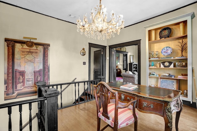 dining area featuring crown molding, wood finished floors, visible vents, and a notable chandelier