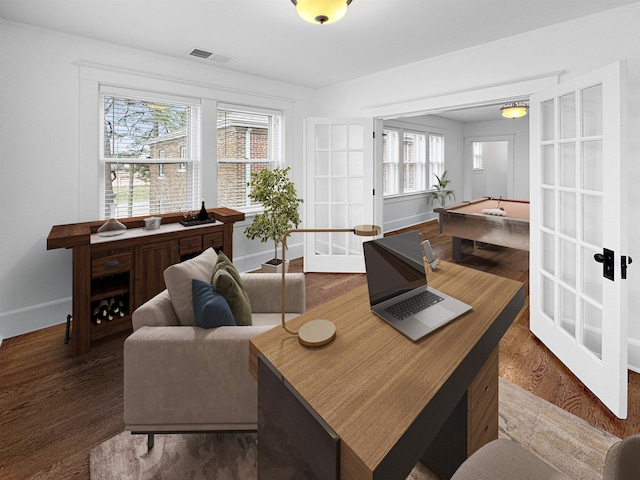 living area with baseboards, visible vents, wood finished floors, and french doors