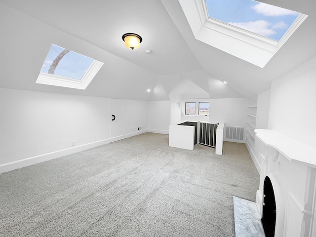 bonus room with lofted ceiling with skylight, visible vents, light carpet, and baseboards