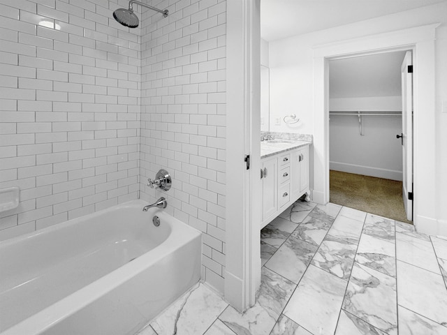 full bath with marble finish floor, vanity, a walk in closet, and shower / bathtub combination