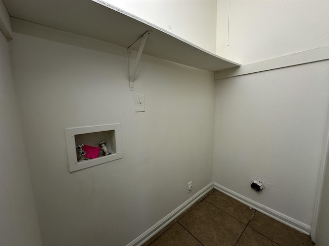 laundry room featuring laundry area, dark tile patterned floors, hookup for a washing machine, and baseboards