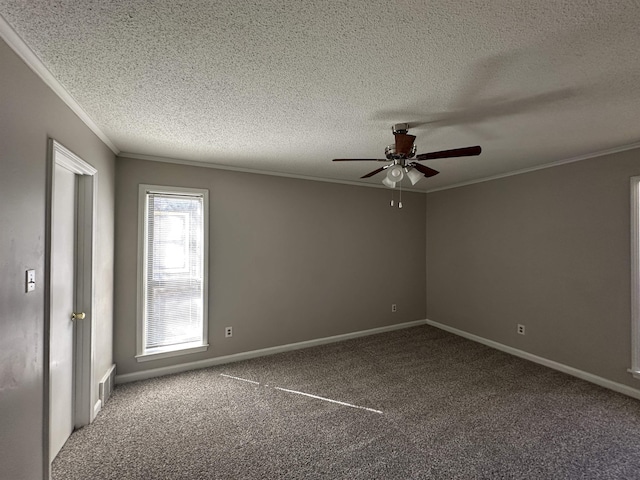 carpeted spare room with ceiling fan, baseboards, and crown molding