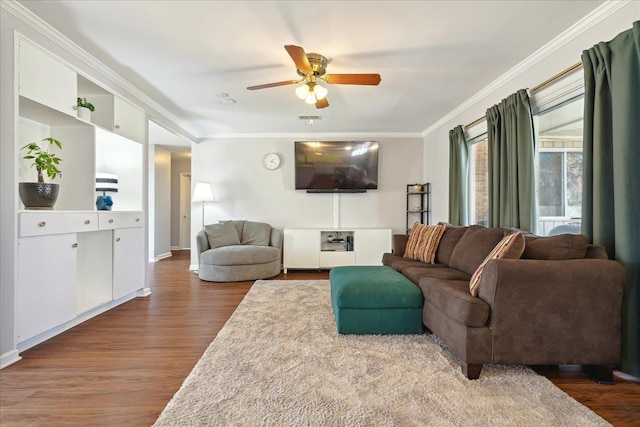 living area featuring a ceiling fan, crown molding, and wood finished floors