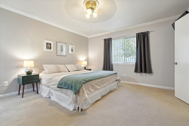 carpeted bedroom featuring crown molding, baseboards, and ceiling fan