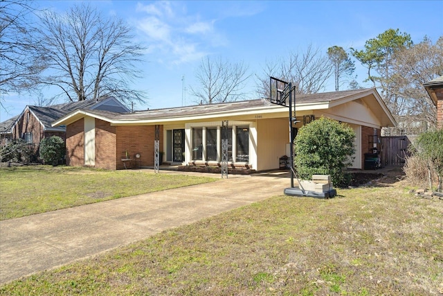 view of front of home with a front yard and brick siding