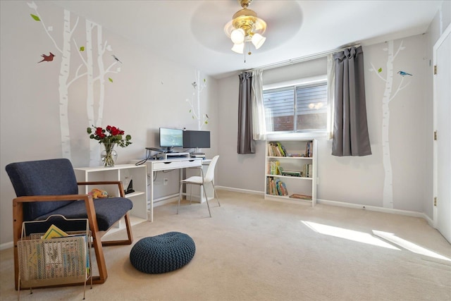 carpeted home office featuring baseboards and a ceiling fan