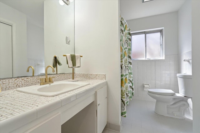 full bath featuring tile walls, toilet, and vanity