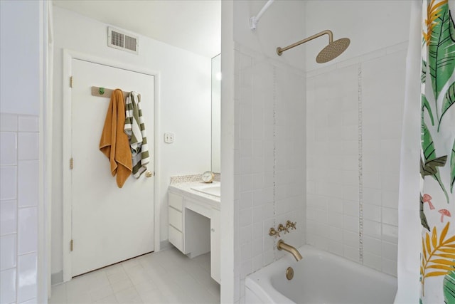 bathroom featuring shower / bath combo, vanity, and visible vents