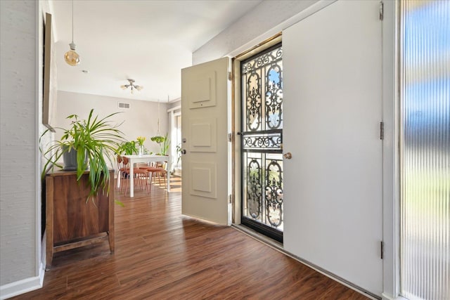 entryway with a wealth of natural light, visible vents, and wood finished floors