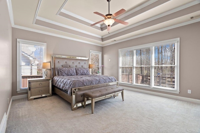 bedroom featuring light carpet, visible vents, baseboards, ornamental molding, and a raised ceiling