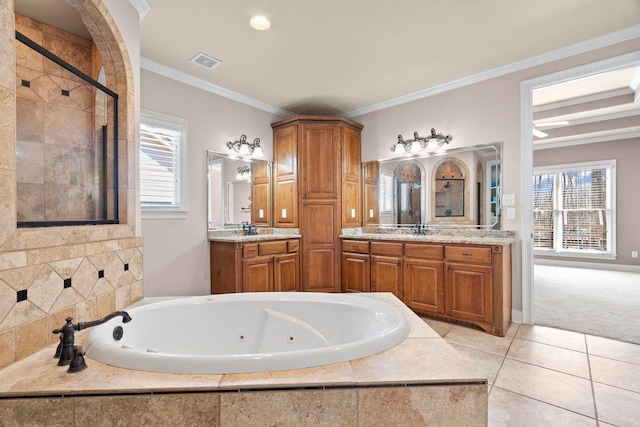 bathroom featuring crown molding, visible vents, vanity, tile patterned flooring, and a tub with jets