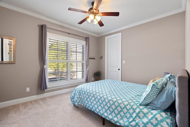 bedroom with baseboards, carpet, a ceiling fan, and crown molding