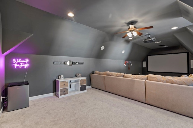 home theater room featuring vaulted ceiling, carpet floors, ceiling fan, and baseboards