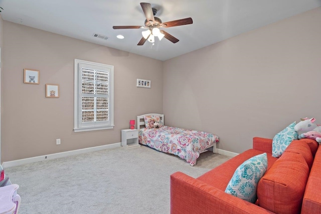 carpeted bedroom featuring baseboards, visible vents, and a ceiling fan