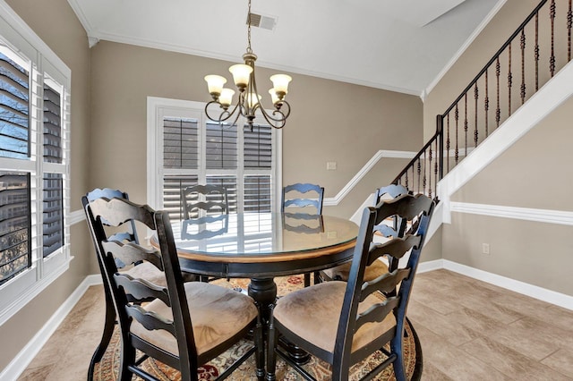 dining area with baseboards, visible vents, a chandelier, and crown molding