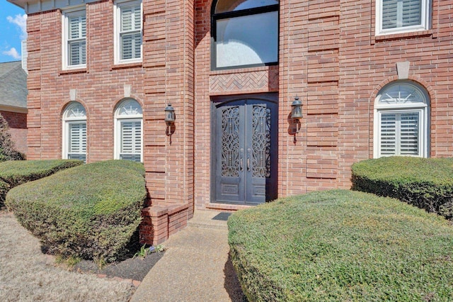 property entrance with french doors and brick siding