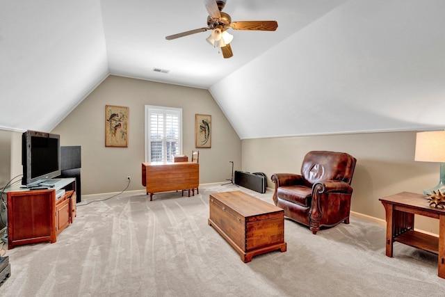 interior space featuring light carpet, baseboards, visible vents, a ceiling fan, and vaulted ceiling